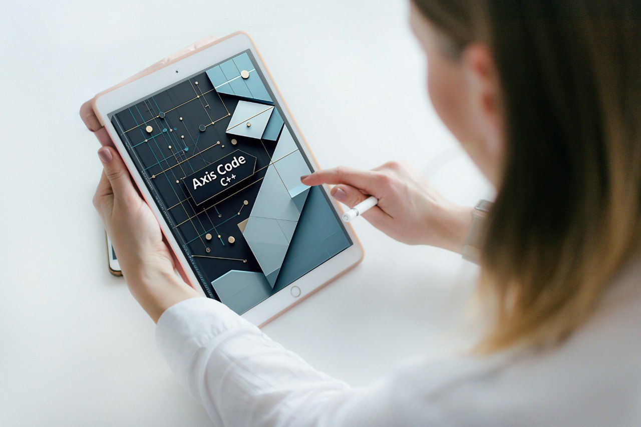 Person using a tablet with a "Axis Code" course on a white surface